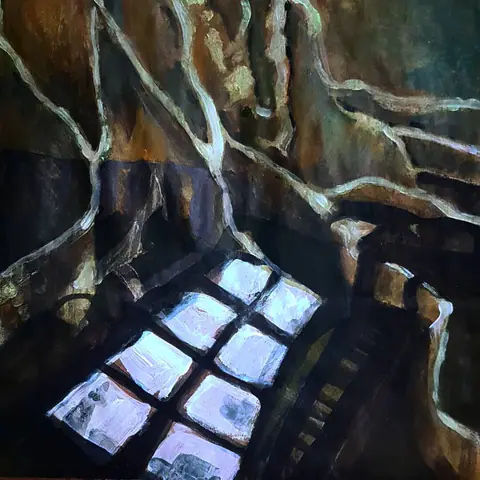 Fenêtre à petits carreaux vue d'en haut, entourée de racines sombres.